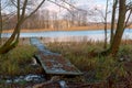 Autumn cloudy wet weather, wooden path near the lake, river pier Royalty Free Stock Photo