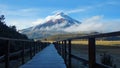 Wooden path near the Limpiopungo lagoon with the Cotopaxi volcano in the background on a cloudy morning Royalty Free Stock Photo