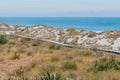 Wooden path over sand beach with ocean seacoast skyline Royalty Free Stock Photo