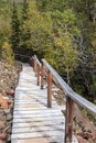 Wooden path on Rock glacier trailhead near Dezadeash lake. Royalty Free Stock Photo