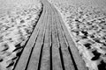 Wooden path through a sandy beach Royalty Free Stock Photo