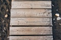 Wooden path on the sandy beach. Top view. Beach boardwalk with sand texture background Royalty Free Stock Photo