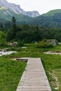 Wooden path to the mountains for tourists. Path for a walk in the woods and mountains Royalty Free Stock Photo