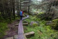 Wooden path in Wicklow way with a excursionist girl