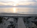 Wooden pathway access atlantic ocean sunset in Lacanau beach France