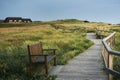 Wooden pathway through high grass on Sylt island in the evening Royalty Free Stock Photo