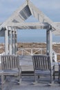 Wooden Patio and two rocker chairs overlook ocean. Royalty Free Stock Photo