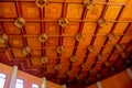 The wooden pattern ceiling is decorated with neon lights