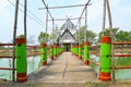 Wooden pavilion in lake with colorful bridge fence