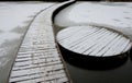 wooden pedestrian bridge over frozen snowy river pond lake no railing Royalty Free Stock Photo