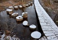 wooden pedestrian bridge over frozen snowy river pond lake no railing Royalty Free Stock Photo