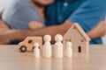 Wooden peg dolls, wooden house, and car with a Hugging man and woman couple. planning, saving family,  health care and insurance, Royalty Free Stock Photo