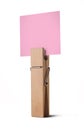 Wooden peg holding a pink note