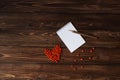 Wooden pencil on the open notebook and red ashberry as a heart shape at the table Royalty Free Stock Photo