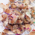 Wooden pencil shavings and colorful crumbs of graphite from sharpener Royalty Free Stock Photo