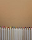 Wooden pencils on a light brown background. Copy space Royalty Free Stock Photo