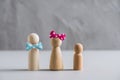 Wooden people man, woman and children against the background of a gray concrete wall. The concept and symbol of the large family. Royalty Free Stock Photo