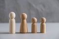 Wooden people man, woman and children against the background of a gray concrete wall. The concept and symbol of the large family. Royalty Free Stock Photo