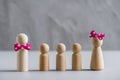 Wooden people man and woman with many children on a gray concrete wall background. The family concept. support for poor families. Royalty Free Stock Photo