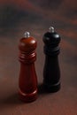 Wooden pepper mill and salt shaker mill on dark background Royalty Free Stock Photo