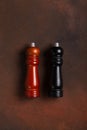 Wooden pepper mill and salt shaker mill on dark background Royalty Free Stock Photo