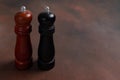 Wooden pepper mill and salt shaker mill on dark background Royalty Free Stock Photo