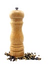 A wooden peppermill with peppercorns Royalty Free Stock Photo