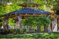 Wooden pergola at the beautiful green garden with flowers Royalty Free Stock Photo