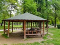 Wooden pergola with green roof in city park