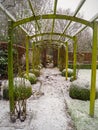 Wooden pergola structure during winter in a snow covered garden