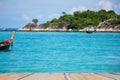 Wooden perspective and clam sea beautiful with boats at Southern Thailand Royalty Free Stock Photo