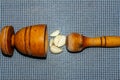 wooden pestle and mortar with garlic cloves on a textured Royalty Free Stock Photo