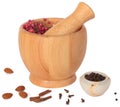 Wooden pestle and mortar with some spices on white Royalty Free Stock Photo