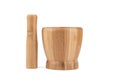 Wooden pestle next to a wooden mortar on a white background. Royalty Free Stock Photo