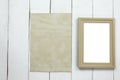 Wooden photo frame and old empty vintage paper on white wooden f