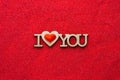 Wooden phrase I heart you on red sand top view