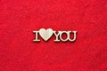 Wooden phrase I heart you on red sand top view