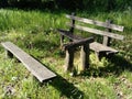 Wooden picnic table and bench in a forest. Quiet place. Summer and green grass Royalty Free Stock Photo