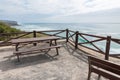 Wooden picnic table and bench overlooking the ocean Royalty Free Stock Photo