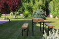 Wooden picnic table with benches in park Royalty Free Stock Photo