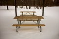 Wooden picnic table and chairs in winter snow Royalty Free Stock Photo