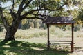 wooden picnic table on the oak tree meadow Royalty Free Stock Photo