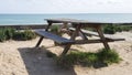 Wooden picnic table overlooking ocean sea beach Royalty Free Stock Photo