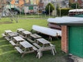 Wooden Picnic Tables On The Grass Outdoors