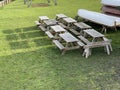 Wooden Picnic Tables Near Boats Stored Outdoors