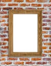 Wooden picture frame hanging on red brick wall