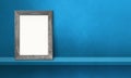 Wooden picture frame leaning on a blue shelf. 3d illustration. Horizontal banner Royalty Free Stock Photo