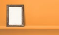 Wooden picture frame leaning on orange shelf. 3d illustration. Horizontal banner Royalty Free Stock Photo