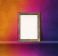 Wooden picture frame leaning on a rainbow shelf. 3d illustration. Square background Royalty Free Stock Photo