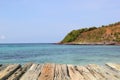 Wooden pier on the beach with turquoise sea and blue sky, wooden table, wooden floor, Sea of Thailand. Royalty Free Stock Photo